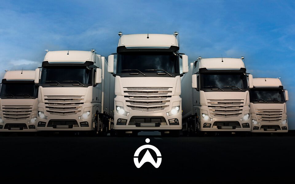 Five large white trucks lined up on a dark road, set against a blue sky, with a logo prominently displayed in the foreground.