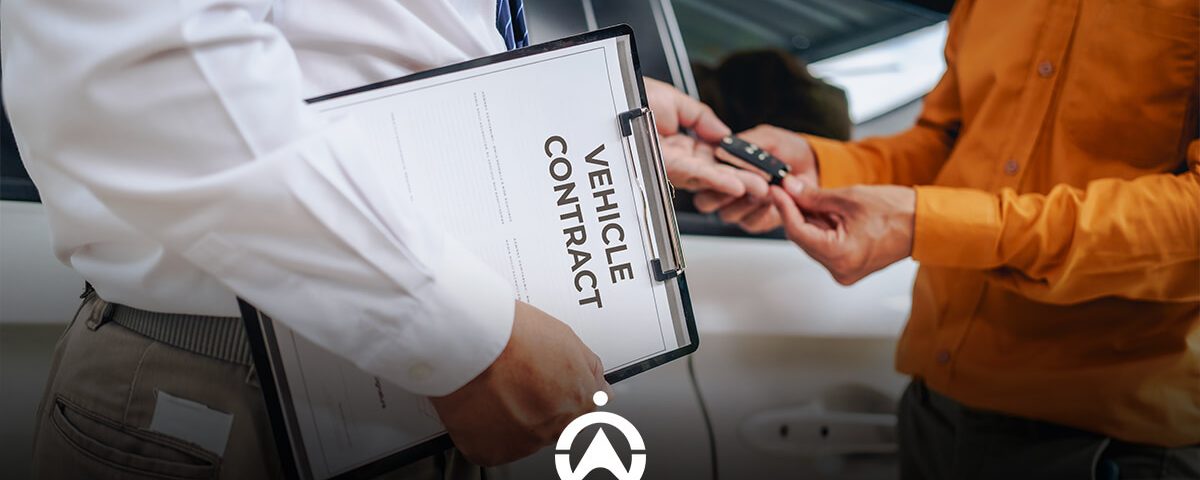 A person in a white shirt holds a vehicle contract while handing car keys to another individual in an orange shirt.