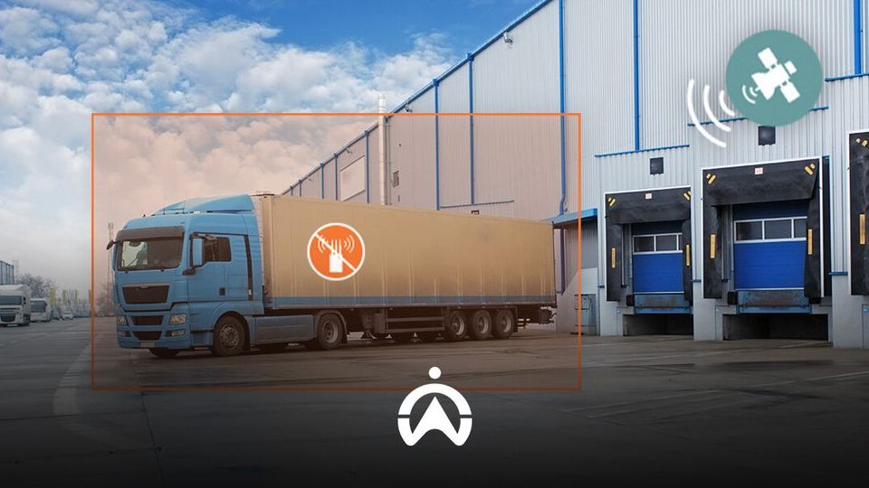 A blue truck parked outside a warehouse, featuring a no-sound symbol, with loading docks visible in the background and satellite signal icons.