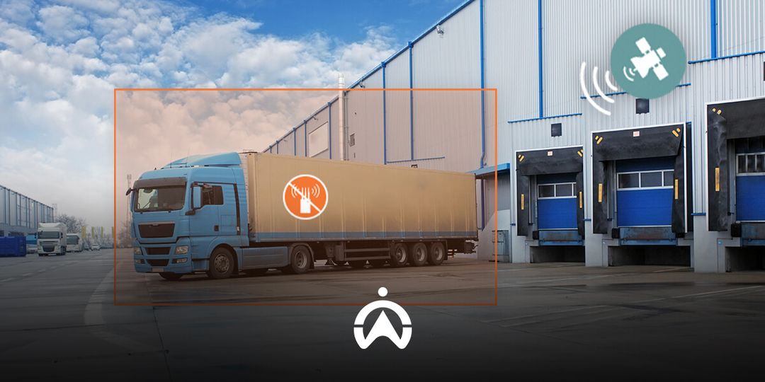 A blue truck parked outside a warehouse, featuring a no-sound symbol, with loading docks visible in the background and satellite signal icons.