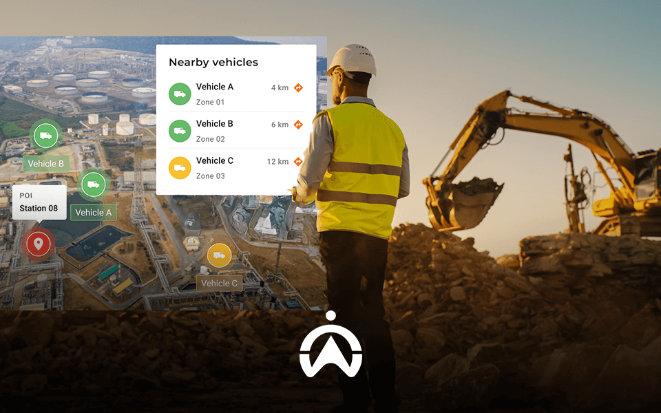 A construction worker in a safety vest stands near heavy machinery, viewing a map displaying nearby vehicles and their distances.