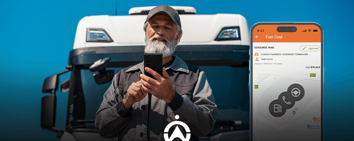 A man in work attire stands in front of a large truck, holding a smartphone displaying fuel cost details, set against a blue sky.