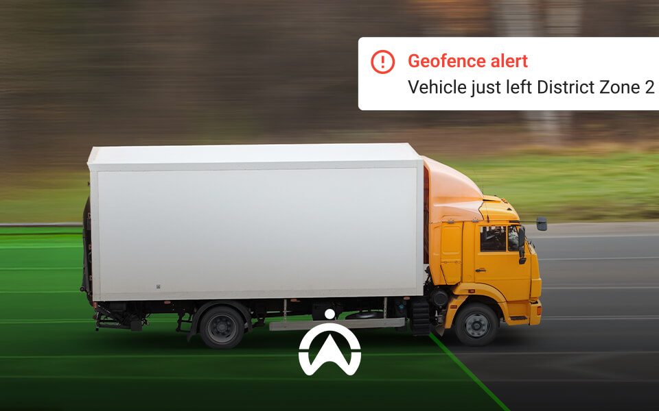 A yellow truck departs a designated zone, triggering a geofence alert notification about leaving District Zone 2.