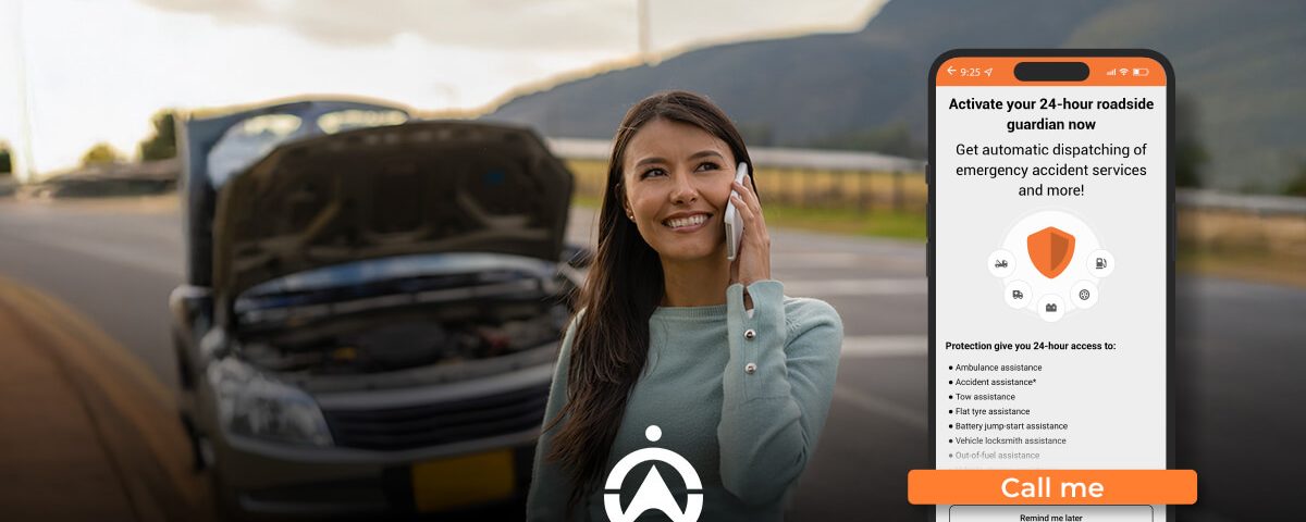 A woman stands beside a broken-down car, holding a phone, with a roadside assistance app displayed on her phone screen.