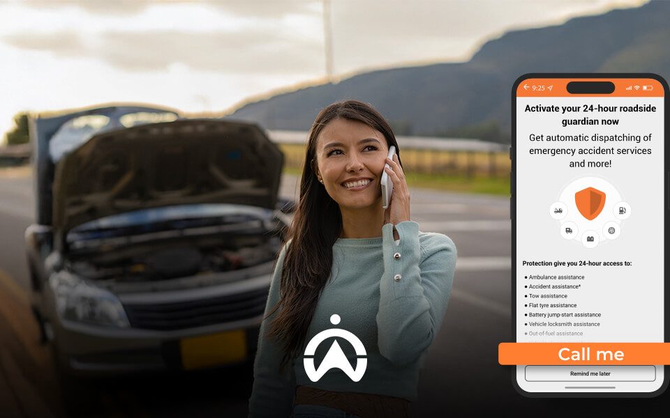 A woman stands beside a broken-down car, holding a phone, with a roadside assistance app displayed on her phone screen.