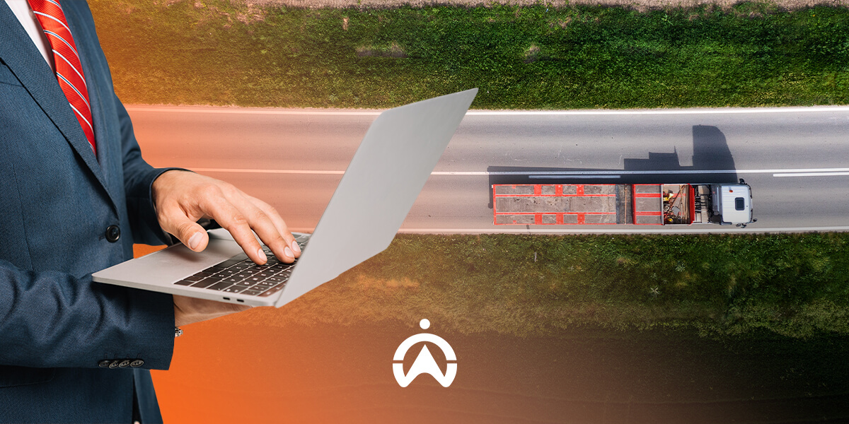 A businessman in a suit uses a laptop while an aerial view shows a truck driving on a highway surrounded by greenery.