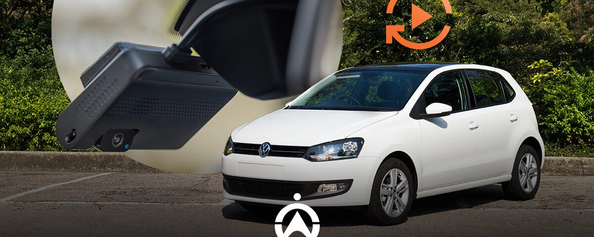 A white Volkswagen Polo parked, with a close-up of a dashcam and a play icon superimposed, suggesting video recording feature.