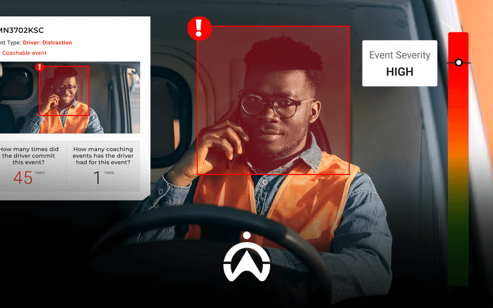 A driver in a safety vest inside a vehicle, with a high severity alert about driver distraction on a digital display.