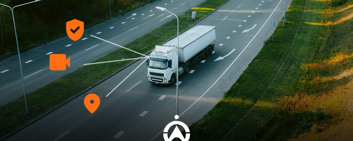 A white truck drives on a highway with icons representing video, location, and safety monitoring above it.