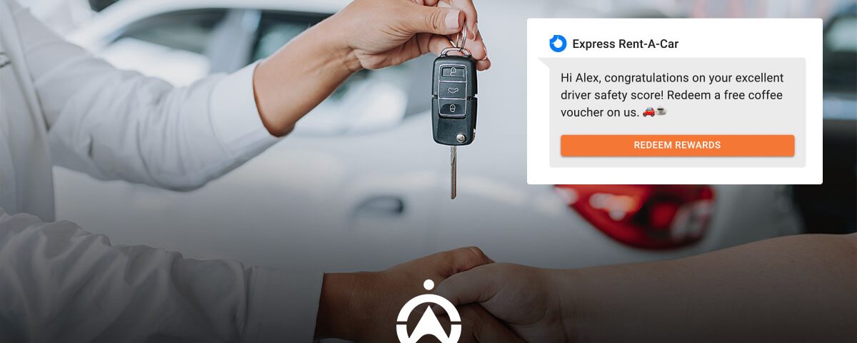 A hand is receiving car keys with a notification congratulating a driver on their safety score and offering a coffee voucher.