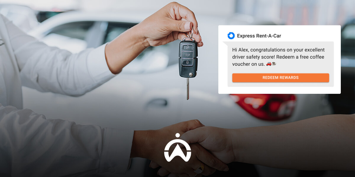 A hand is receiving car keys with a notification congratulating a driver on their safety score and offering a coffee voucher.