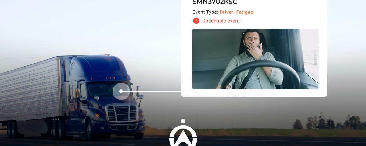 A blue semi-truck drives along a highway, while a digital alert indicates "Driver: Fatigue" next to a video of the driver.