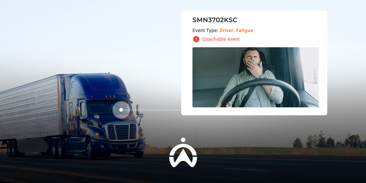 A blue semi-truck drives along a highway, while a digital alert indicates "Driver: Fatigue" next to a video of the driver.