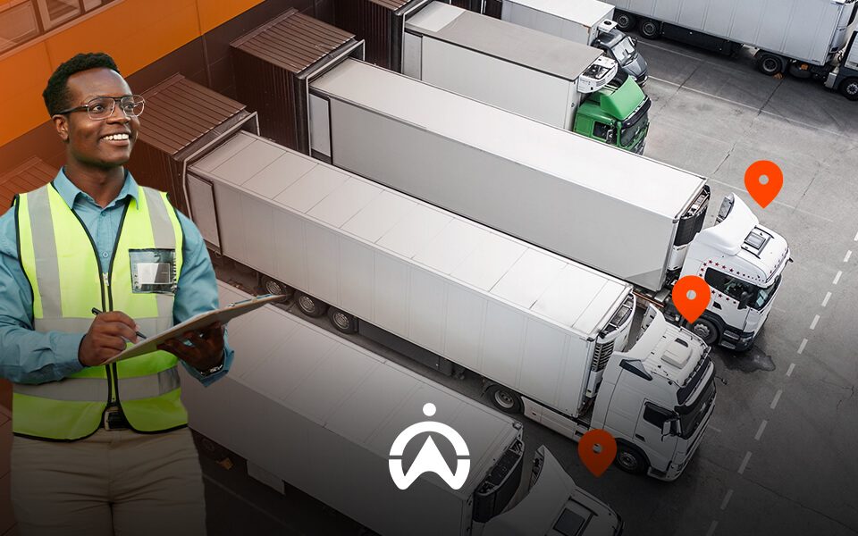 A logistics worker in a safety vest holds a clipboard, overseeing multiple parked trucks in a warehouse area with location markers.