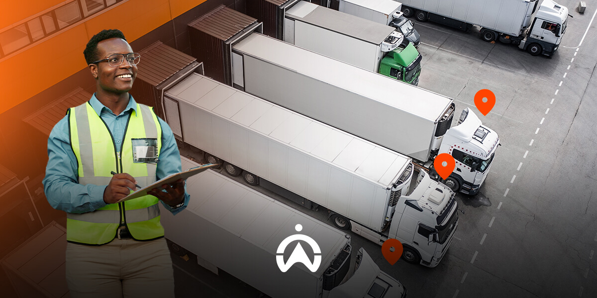 A logistics worker in a safety vest holds a clipboard, overseeing multiple parked trucks in a warehouse area with location markers.