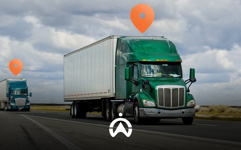 Two green semi-trucks drive on a highway under a cloudy sky, with location markers above them symbolizing tracking.