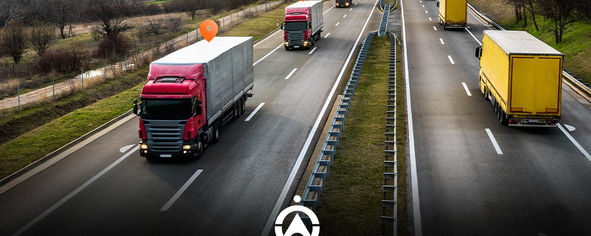 A busy highway with multiple trucks, including red and yellow ones, and location markers indicating tracking points.